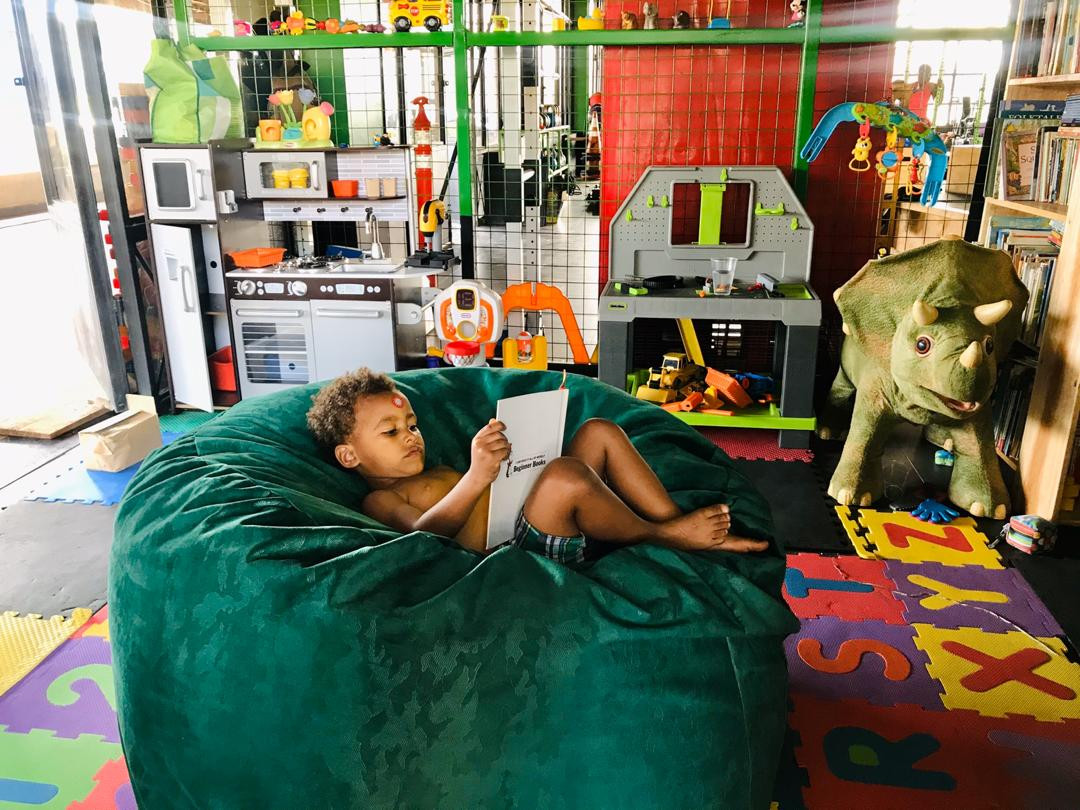 Child reading in the MetaFit256 kids play area
