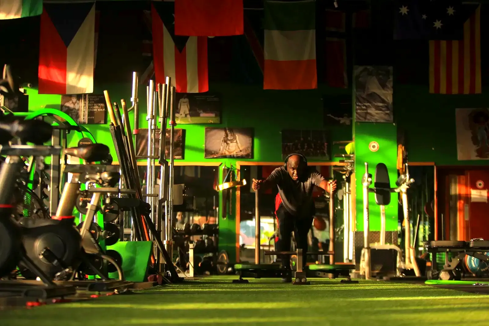 Member pushing a sled across the MetaFit256 turf